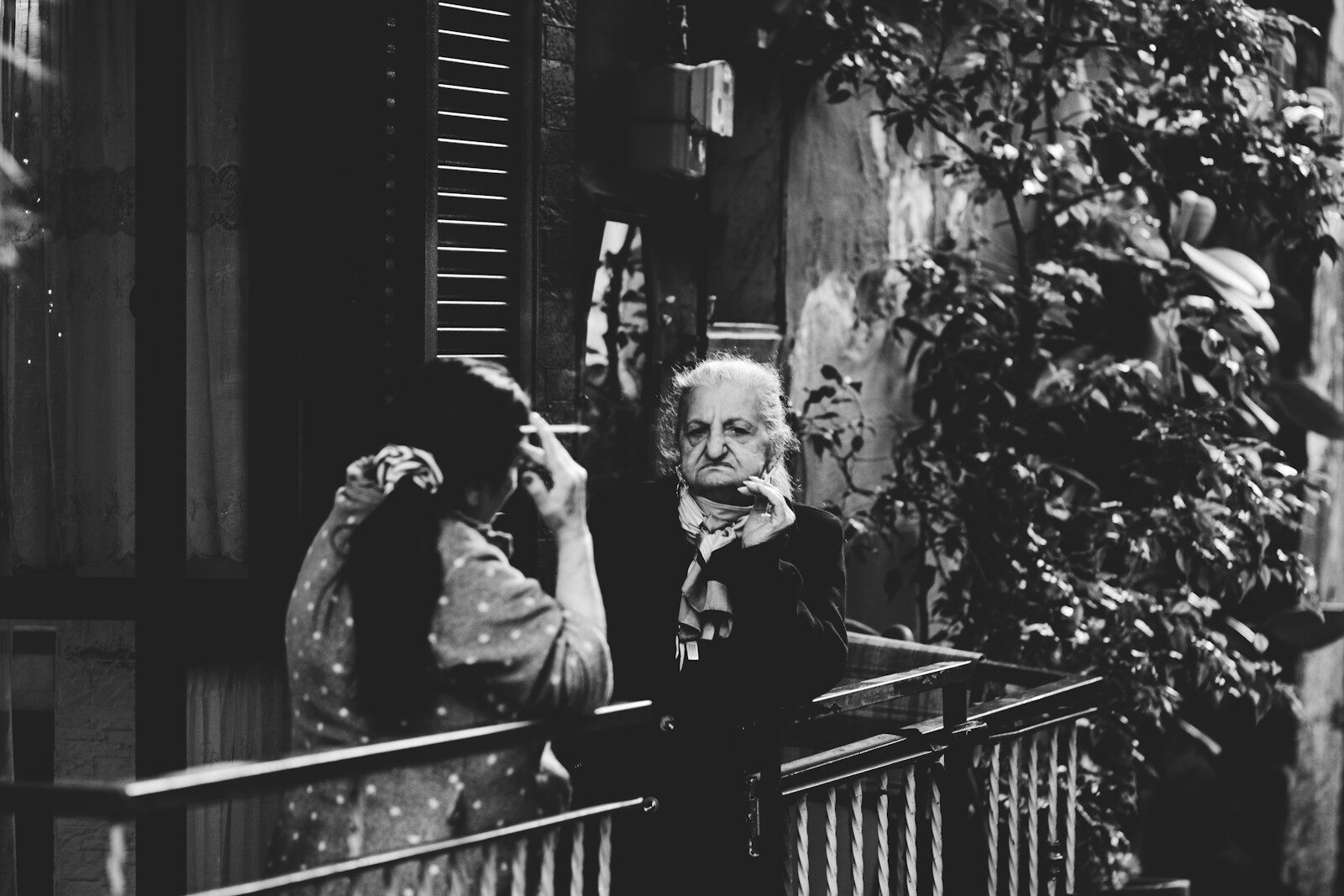 a man and a woman standing on a balcony
