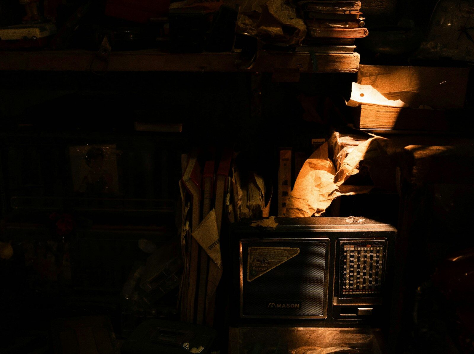 Vintage radio sits in a dimly lit, cluttered room.